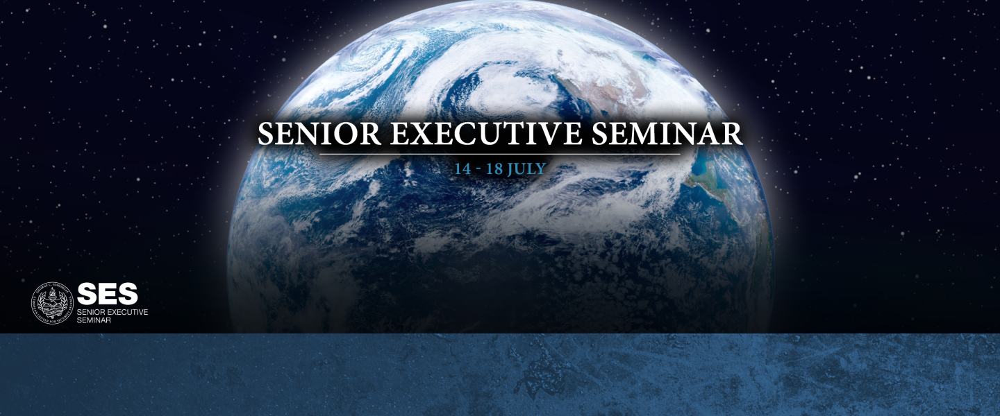 Graphic for the Senior Executive Seminar, showing Earth from space with stars in the background. Text across the center reads “Senior Executive Seminar, 14–18 July.” The Marshall Center logo and the acronym "SES" appear in the lower-left corner on a textured blue background.